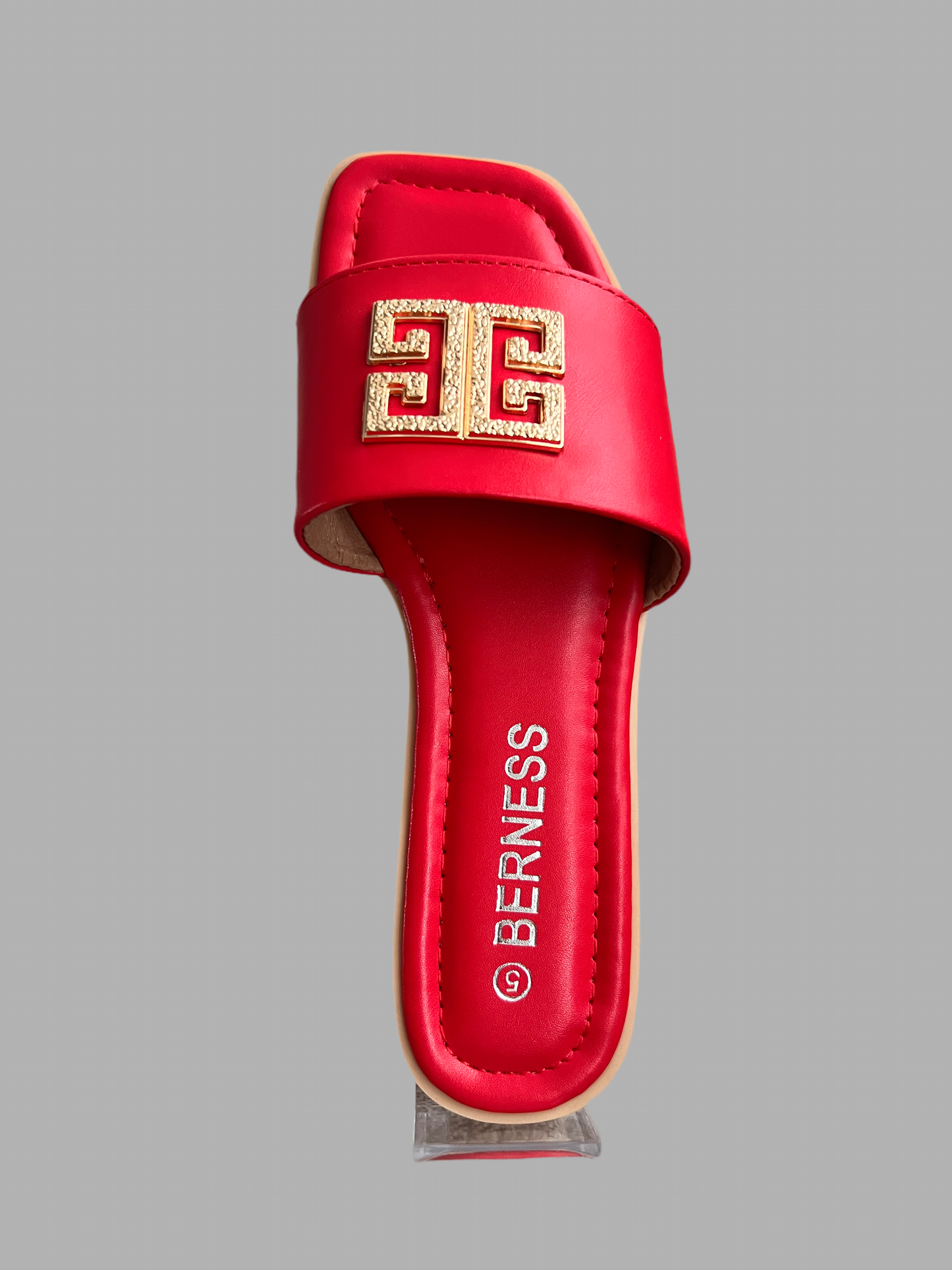 Camber Red flat sandal with gold detail on the front