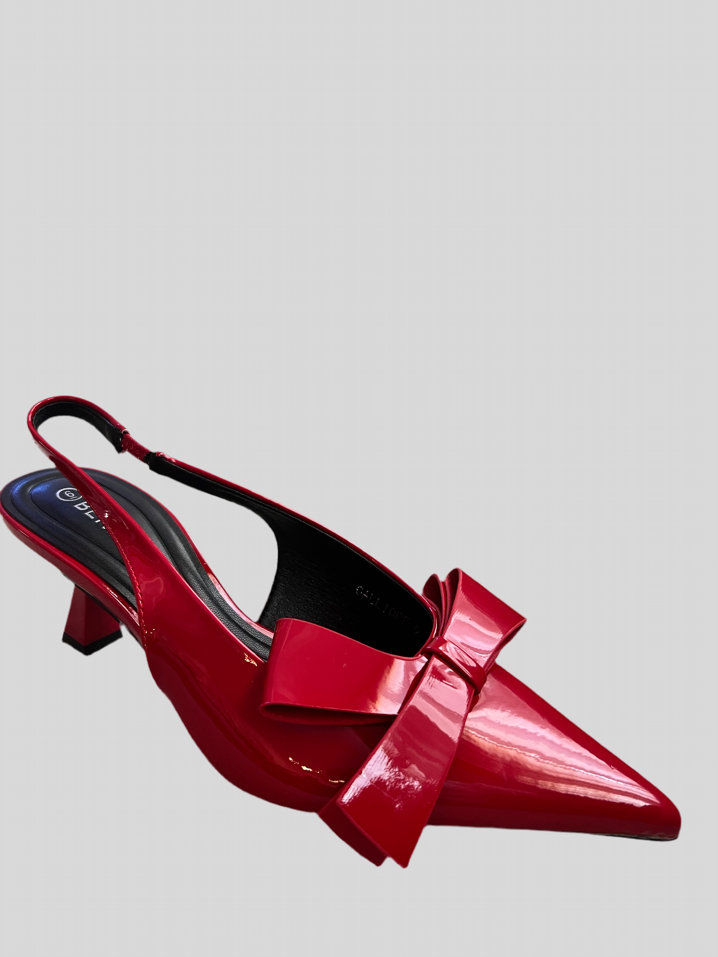Red patent pointed shoe with asymmetric bow